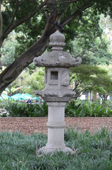 Fototapeta na wymiar A stone lantern in Nagoya Gardens in Hyde Park, Sydney. The gardens celebrate the relationship between Sydney and its Sister City of Nagoya in Japan.