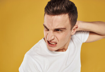 Obraz premium Aggressive man touches his head emotions model irritability