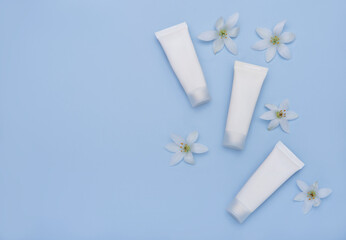 White tubes of cream on a blue background