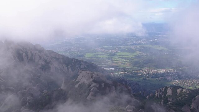 Cloudy Aerial View of Natural Landmark Mountain Montserrat, Catalonia, Spain, Tilt Shot