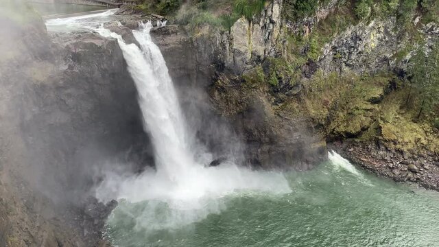 Water plunging over the Snoqualmie Falls in Washington State, with mist rising around it. This is the falls seen in the opening of Twin Peaks