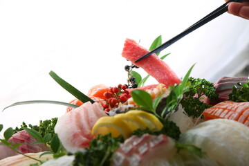 Chopsticks holding sashimi on a simple background  심플한 배경에 회를 집고있는 젓가락