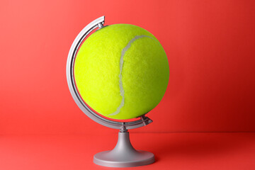Globe made of tennis ball on color background