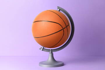 Globe made of ball for playing basketball on color background