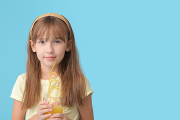 Cute little girl with orange juice on color background