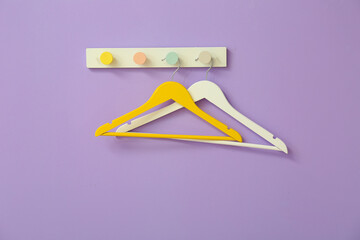 Different hangers on color background