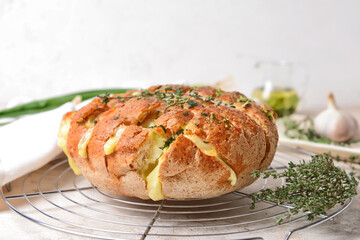 Fresh garlic bread and thyme on light background, closeup
