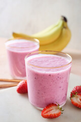 Glasses of tasty berry smoothie on color background