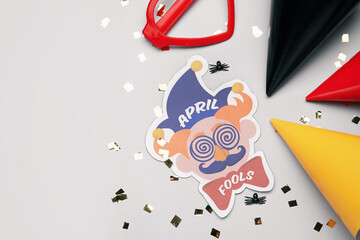 Party decor for April Fools Day on grey background