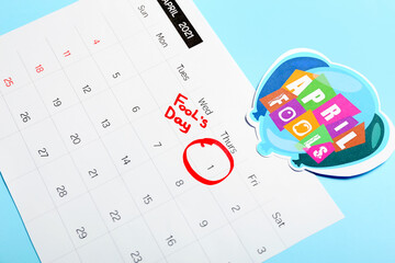 Calendar with marked date of April Fool's Day on color background