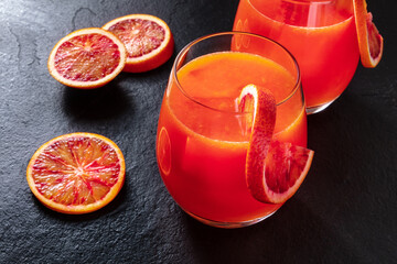 Orange cocktails with blood orange slices on a black background