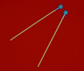 Xylophone
mallets on a red background.