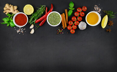 Colorful various herbs and spices for cooking on dark background. Copy space, mock up