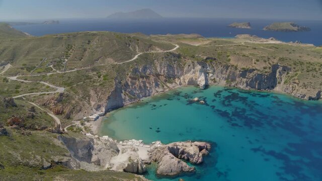 Aerial of a Bay Surrounded by Cliffs on the Blue Aegean Sea in Milos Greece