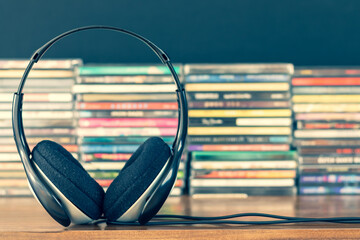 headphone on stack of cd background - 417767034