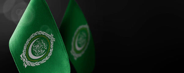 Small national flags of the Arab League on a dark background