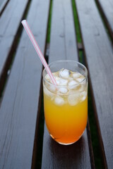 Summer fresh cold drink beverages. Ice Lemonade, orange juice and spirits in glasses  on the table outdoor. Refreshing cocktail. It is called 