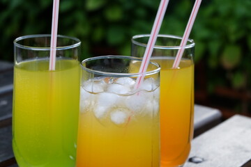 Summer fresh cold drink beverages. Ice Lemonade, orange juice and spirits in glasses  on the table outdoor. Refreshing cocktail. It is called 