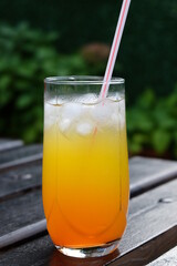 Summer fresh cold drink beverages. Ice Lemonade, orange juice and spirits in glasses  on the table outdoor. Refreshing cocktail. It is called 