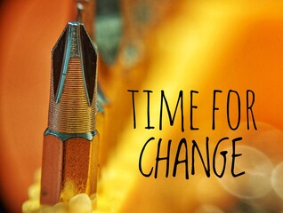 'Time For Change' motivation quote. Close up picture of screwdriver bit captured by macro lens with bokeh background.