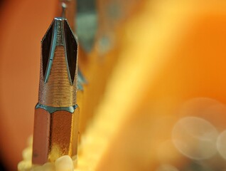 Close up macro of screwdriver bit with blurry background.
