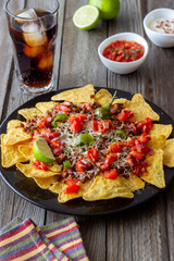 Corn chips nachos with meat, cheese, tomatoes and peppers. Mexican food. National cuisine.