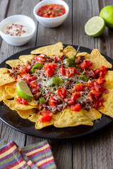 Corn chips nachos with meat, cheese, tomatoes and peppers. Mexican food. National cuisine.