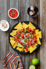 Corn chips nachos with meat, cheese, tomatoes and peppers. Mexican food. National cuisine.