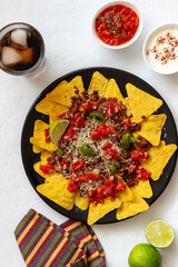 Corn chips nachos with meat, cheese, tomatoes and peppers. Mexican food. National cuisine.