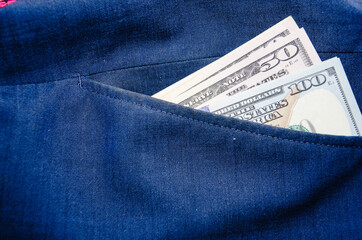 One hundred dollar banknote money in pocket jeans pants background texture. 100 dollar bill close up. Corruption.