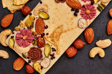 Handmade white chocolate with dried fruits and nuts