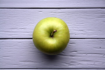 Juicy yellow apples on a grey wooden background.