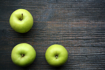 Juicy yellow apples on a wooden background.