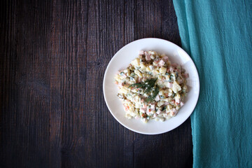 Salad of potatoes, sausage, peas, carrots and cucumbers. Olivier.