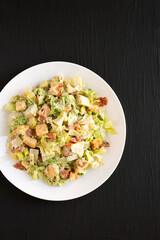 Homemade Bacon Avocado Caesar Salad with Cheese and Croutons, top view. Space for text.