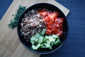 Salad of buckwheat, tomatoes, cucumbers and dill.