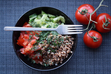 Salad of buckwheat, tomatoes, cucumbers and dill.