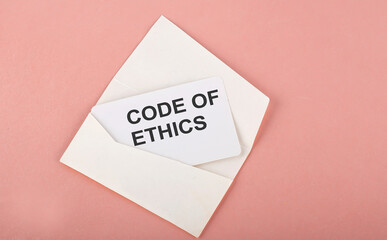 Word Writing Text CODE OF ETHICS on card on the pink background