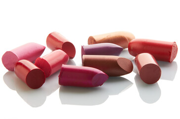 Multi-coloured scraps of lipstick on a mirror with reflexion