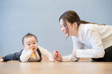 Obraz na płótnie Canvas 室内で、赤ちゃんと遊ぶお母さん