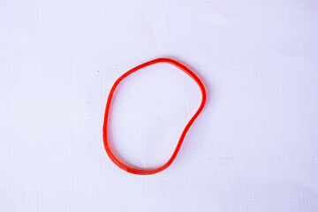 red rubber band. Elastic bands. dragging an elastic band, isolated on white background