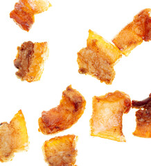 Fried lard cracklings on a white plate.