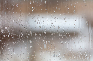 Raindrops on the glass window as a background.