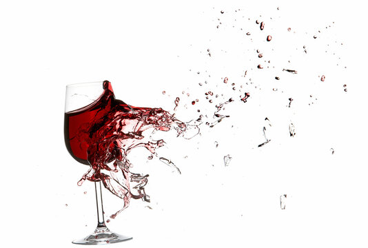 Explosion of a glass with red wine isolated on white.