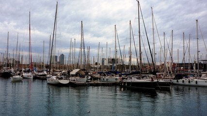Docked yachts at the port in the Mediterranean harbor on an autumn day.