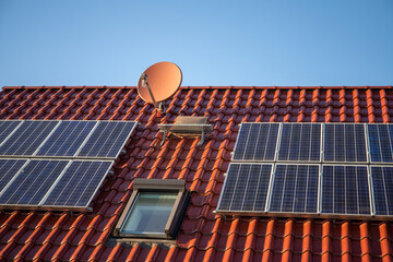 Photovoltaic system on the red tile roof, old version from 2005, 2.4 kWp, renewable energies