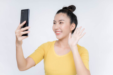 Fototapeta premium Young Asian woman lying on mobile phone