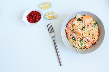 tasty healthy vegetarian dish - italian creamy basil shrimp pasta with pink pepper and lime