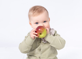 Pretty baby gnaws an apple