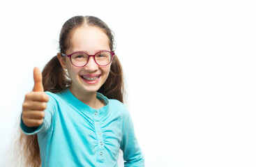 Happy smiling teen girl in blue t-shirt in eyeglasses over white background.